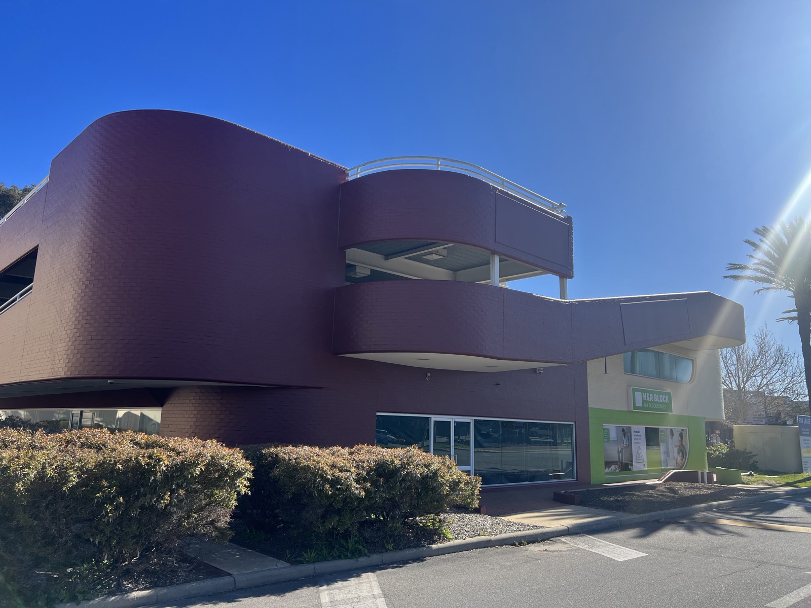 Two-tone maroon and white commercial facade repainted by Super Painting WA